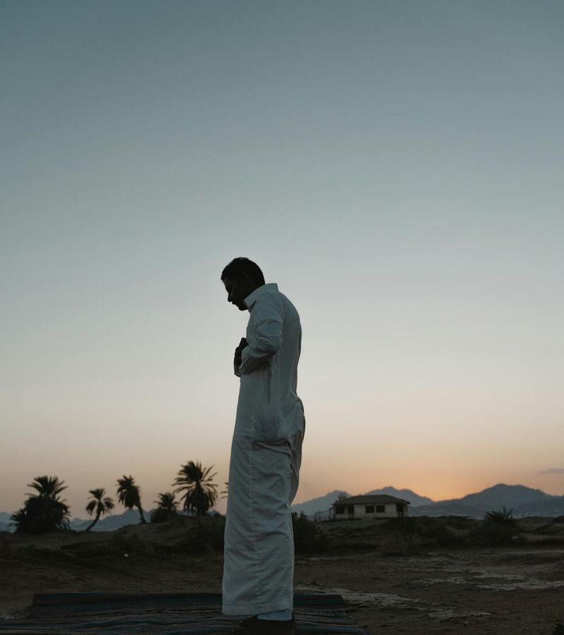 Silhouette of a man at dawn, looking calm and balanced.